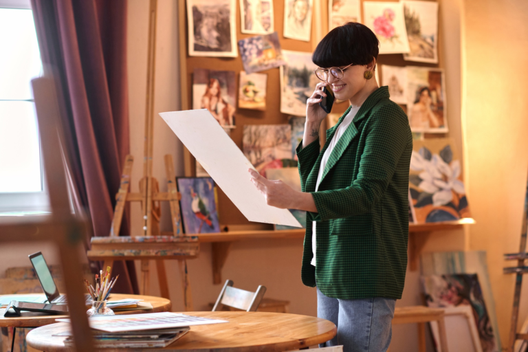 Artist looking at painting