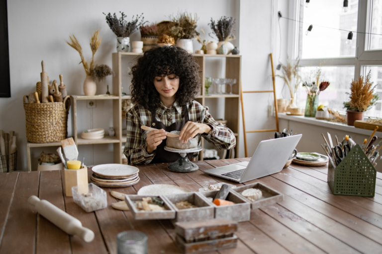 Young woman making pottery in cozy home studio